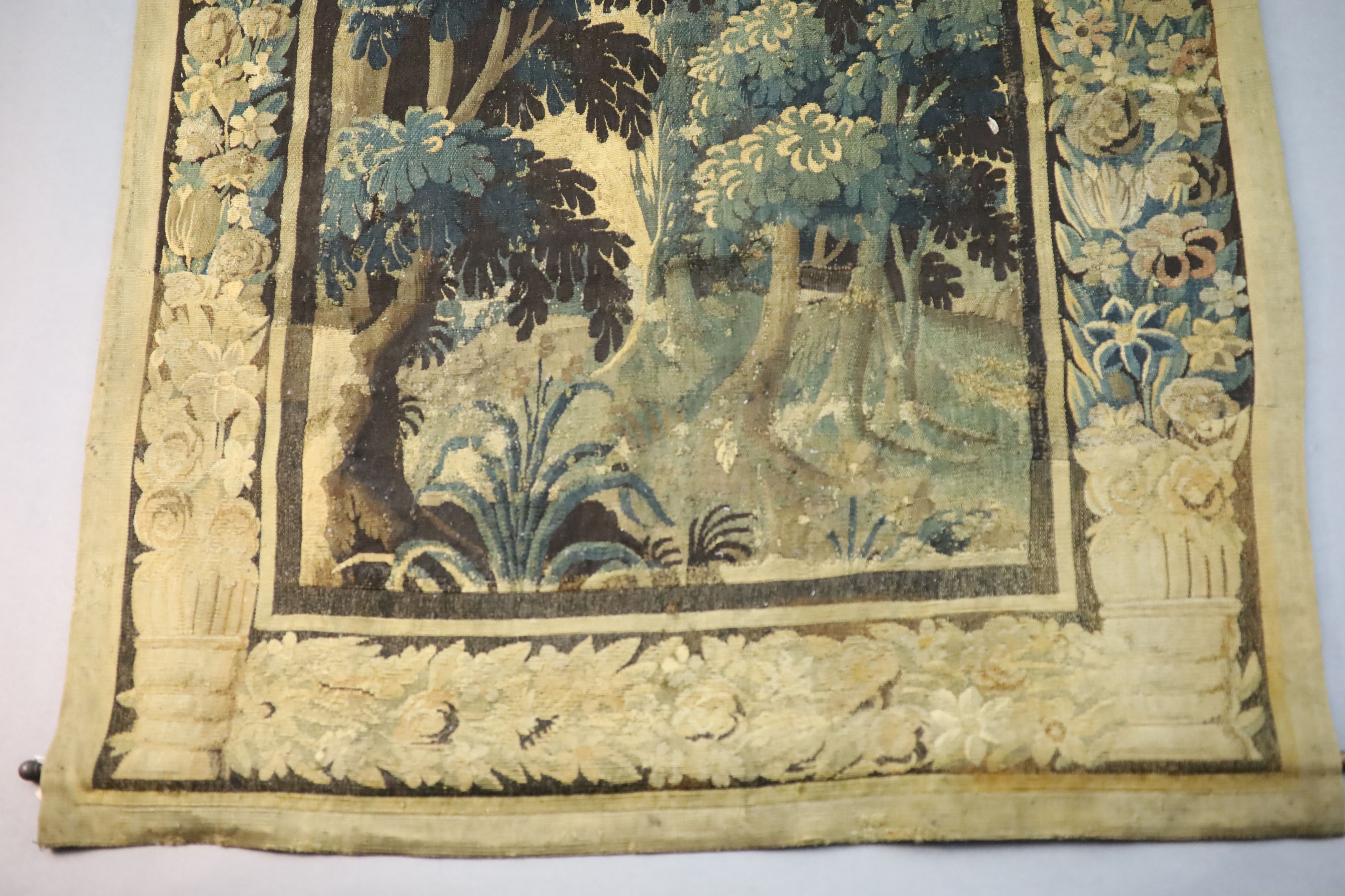 A 17th century Flemish verdure tapestry wall hanging, 8ft 1in. x 3ft 11in.